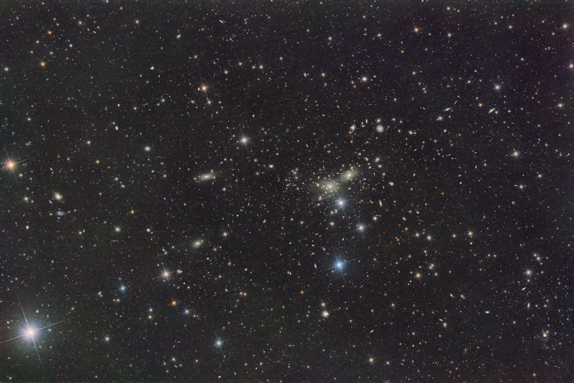 The Coma Galaxy Cluster Abell 1656 is a huge collection of over 1000 galaxies in the constellation Coma Berenices. The galaxy cluster has an angular size of about 3° × 5°.